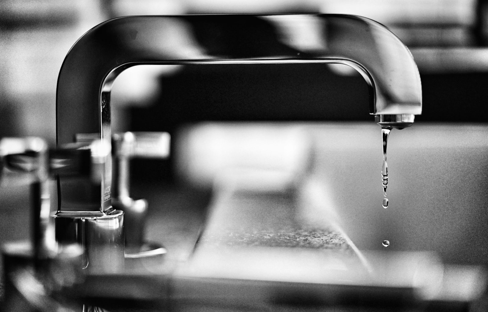 grayscale photography of faucet