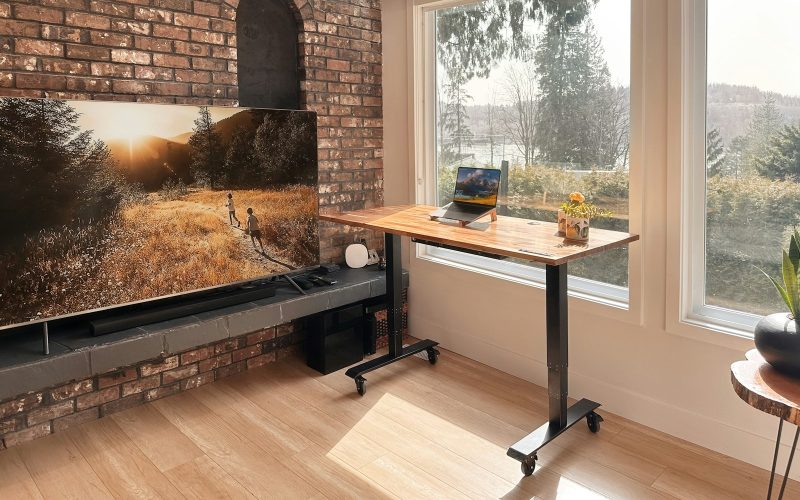 a flat screen tv sitting on top of a wooden table