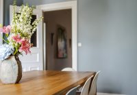 white and pink flower bouquet on brown wooden table