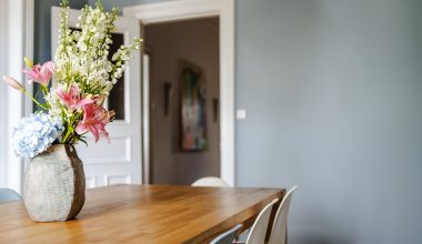 white and pink flower bouquet on brown wooden table