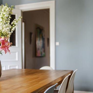 white and pink flower bouquet on brown wooden table