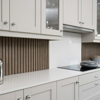 a kitchen with white cabinets and a stove top oven