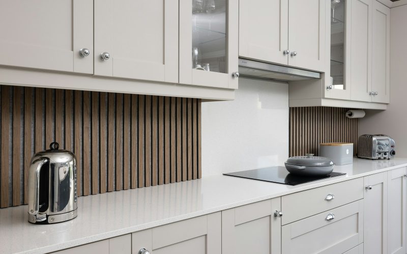 a kitchen with white cabinets and a stove top oven